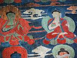 Lo Manthang Thubchen 03-3 Entrance Left Wall Paintings Close Up Pairs of smaller paintings have been restored to the right of Buddha on the left wall before the assembly hall entrance door at Thubchen Gompa in Lo Manthang.